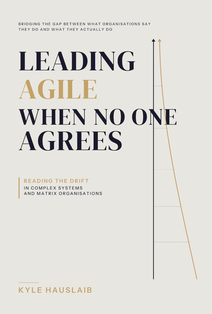 Cover of Leading Agile When No One Agrees by Kyle Hauslaib. Subtitle: The Unwritten Rules of Leading Change in Complex Organizations. Cream background with dark navy serif title and a System A / The Gap / System B diagram showing an orderly grid on the left and scattered tiles on the right.